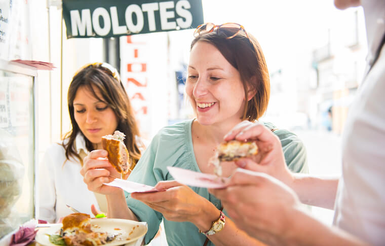 Group enjoying a cemita on our Taste of Puebla Tour