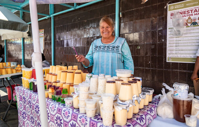 A smiling vendor selling food in Mexico City's Xochimilco neighborhood